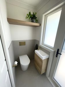 Brand new laundry room renovation with toilet and sink built in. 